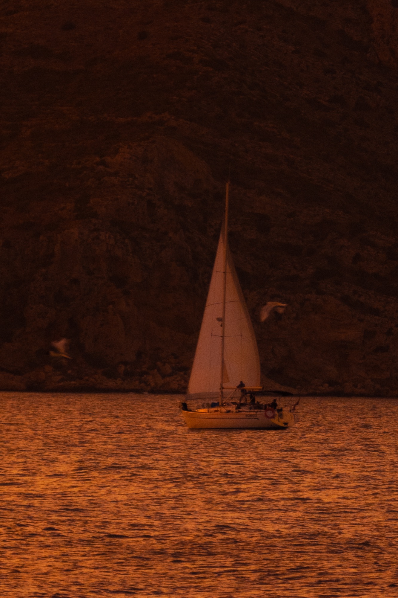 A sailboat under the cliffs at dusk, Jávea